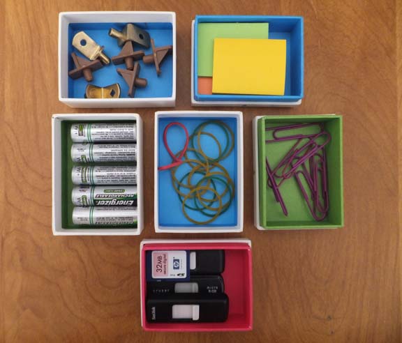 creatively reuse small gift boxes for office and utility supplies.