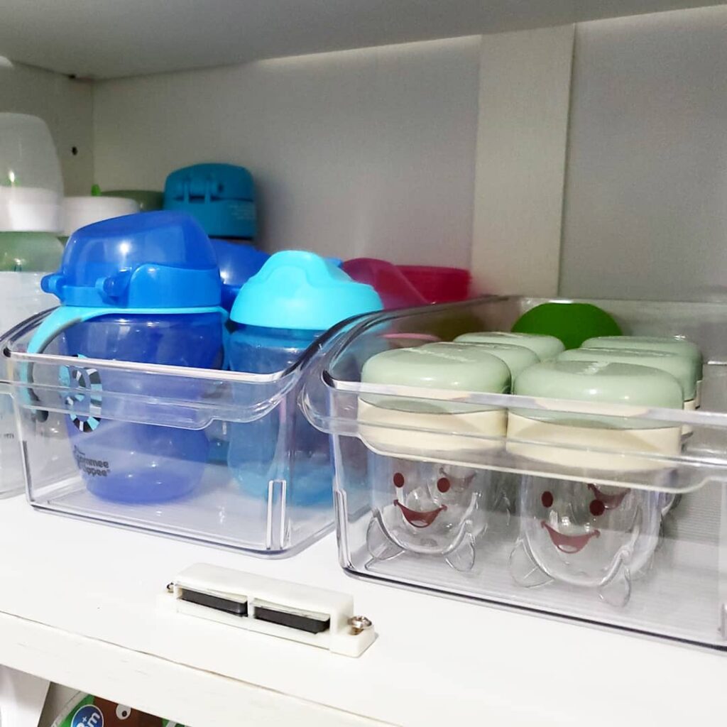 magic baby bullet and kids cups and dishes in clear acrylic plastic container bins Bella Organizing Professional home organizers and residential packing and moving management company serving the San Francisco Bay Area.