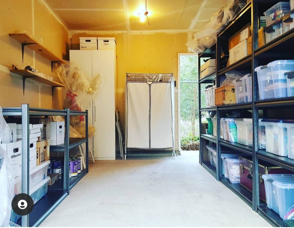 Garage with clear bins and metal shelves from Costco white cabinets Bella Organizing Professional Home Organizers in Oakland and the San Francisco Bay Area