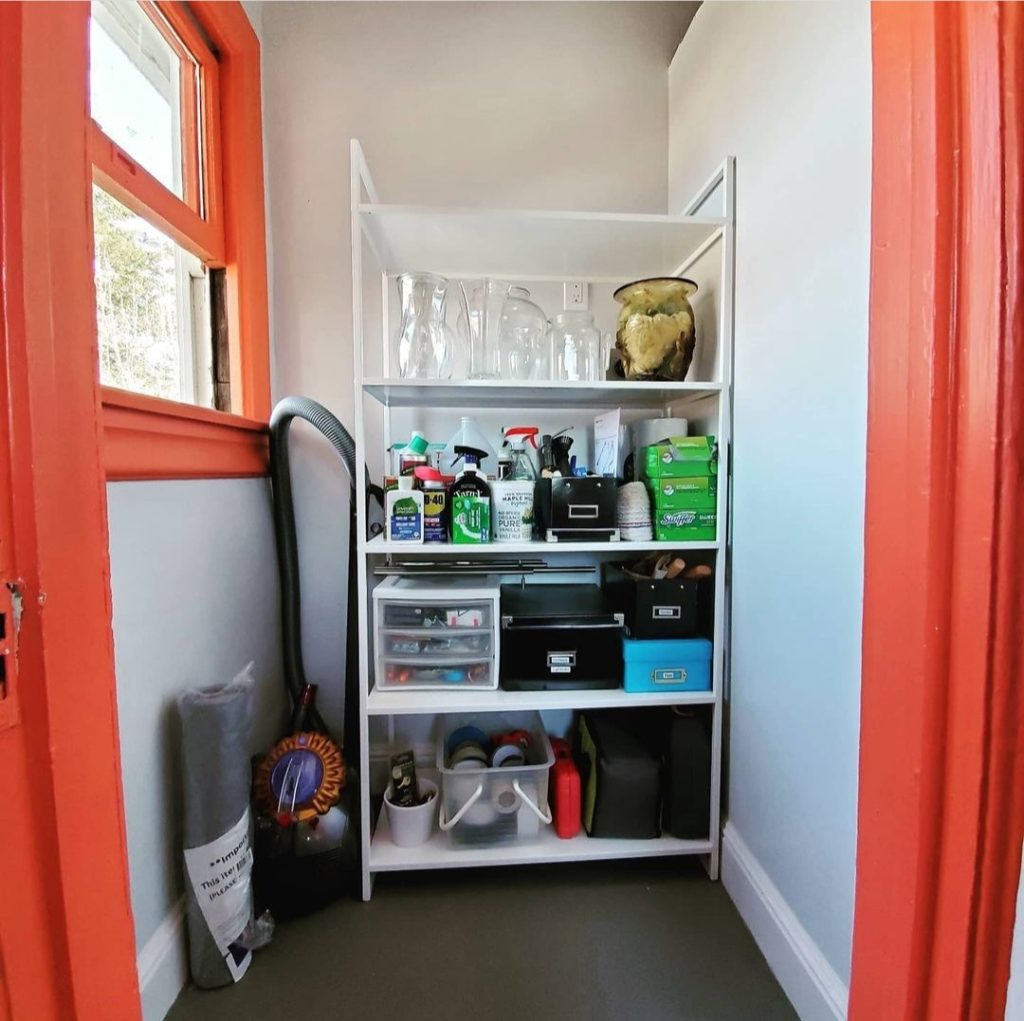 Utility Closet Storage with white metal shelf and Orange paint trim by Bella Organizing Professional Home Organizers in Oakland and the San Francisco Bay Area