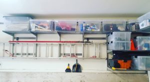 Garage shelves with horizontal hanging ladder and clear plastic bins Bella Organizing Professional Home Organizers in Oakland and the San Francisco Bay Area