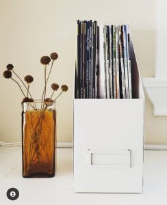 White metal magazine and paper file storage brown glass vase with dried flowers Bella Organizing Professional home organizers and residential packing and moving management company serving the San Francisco Bay Area.