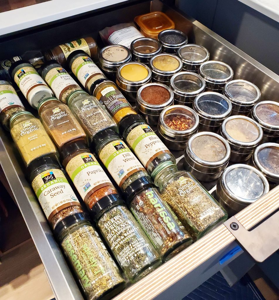 spice drawer customer made by Henrybuilt round metal and glass spice holders Bella Organizing Professional home organizers and residential packing and moving management company serving the San Francisco Bay Area.