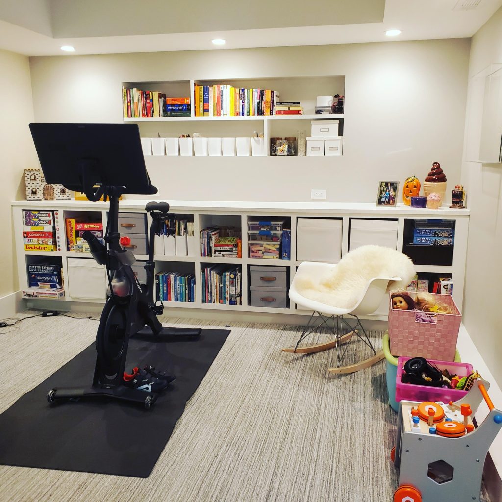 Kids playroom with cube shelves and baskets in an exercise Pelaton room Bella Organizing Professional Home Organizers in Oakland and the San Francisco Bay Area