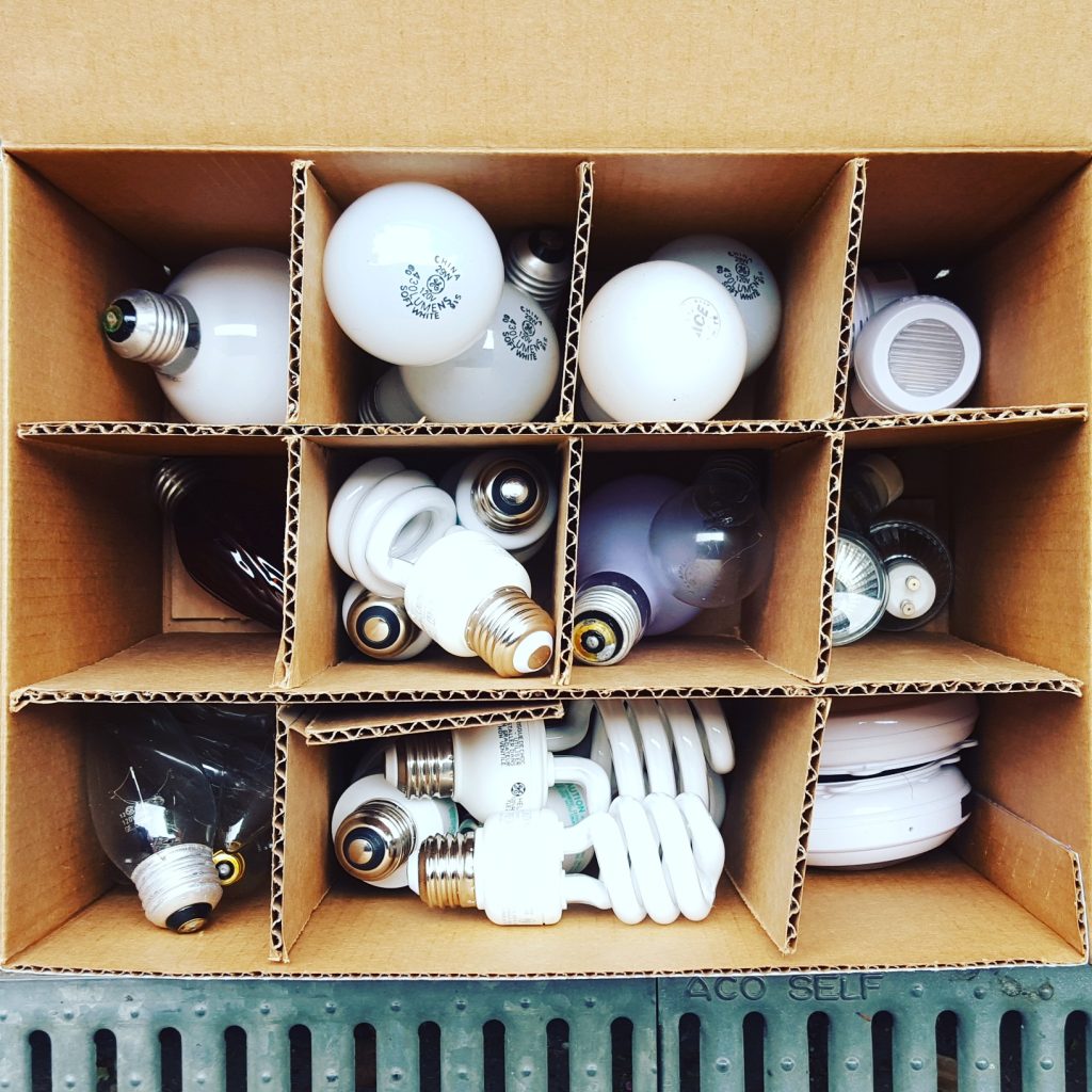Creative cardboard container storage for lightbulbs in the garage by Bella Organizing Professional Home Organizers in Oakland and the San Francisco Bay Area